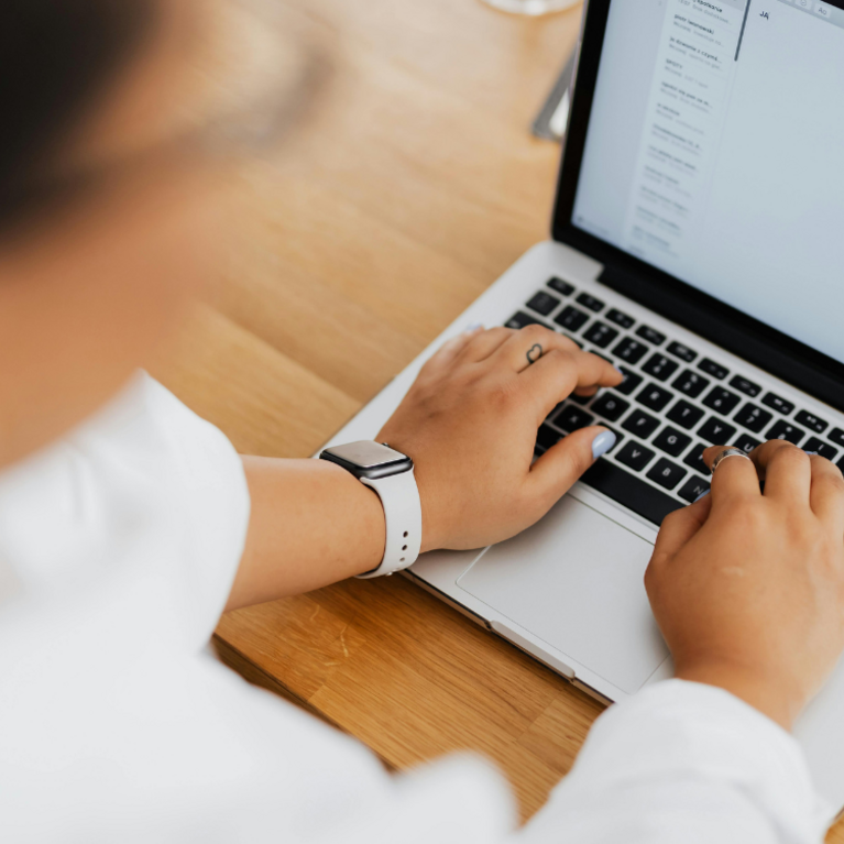 Person shown using a laptop and typing an email